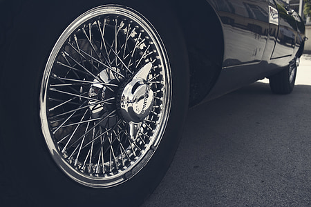 black vehicle with wire spoke wheel thumbnail