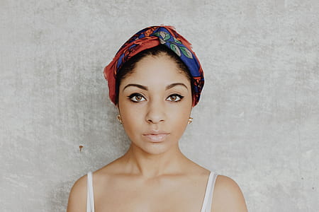 woman standing beside wall thumbnail