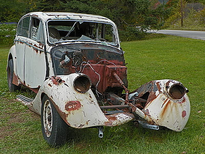 wrecked classic white vehicle on green grass field at daytime thumbnail