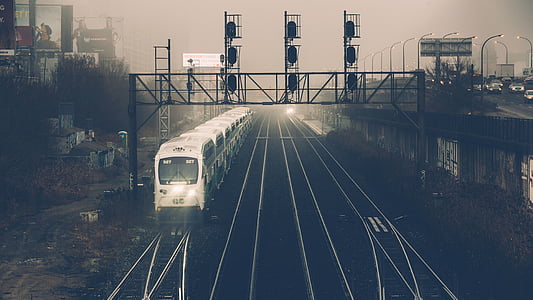 white train traveling in black railroad thumbnail