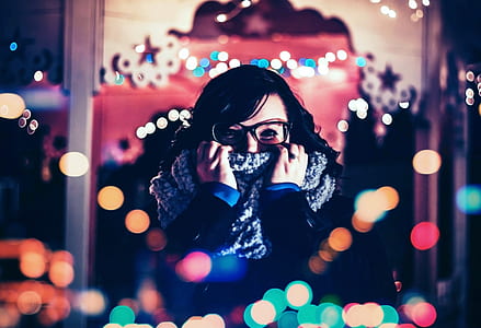 shallow focus photography of woman covering her face with gray knitted scarf thumbnail