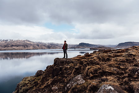 man standing beside body of water during daytime thumbnail