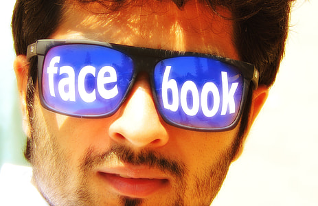 man in black-framed blue lens tinted Facebook print sunglasses thumbnail