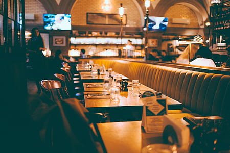 brown wooden dining sets beside standing woman in restaurant thumbnail