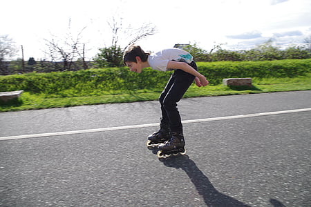 boy inline skating on road thumbnail