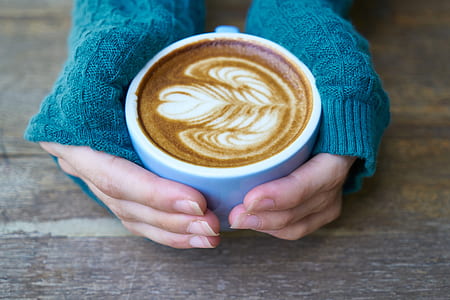 person holding white coffee mug thumbnail