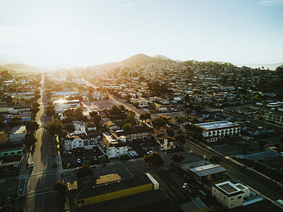 aerial photography of buildings and streets under white clouds during daytime thumbnail