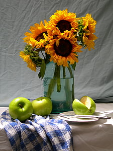 sun flowers on clear glass vase thumbnail