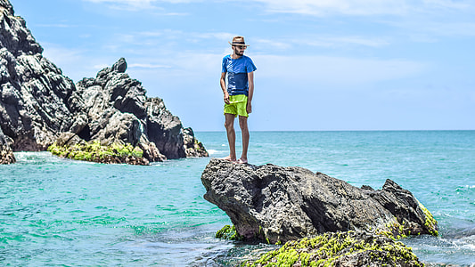 man standing on rock formation thumbnail