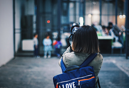woman holding black camera DSLR taking picture thumbnail