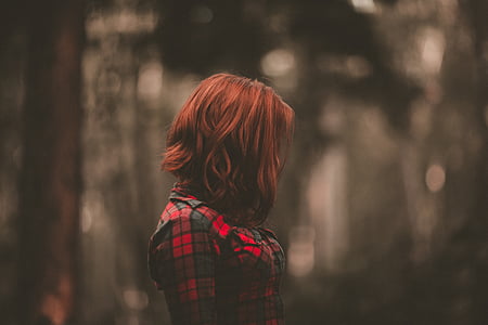 tilt shift photography of woman wearing red and black plaid top thumbnail