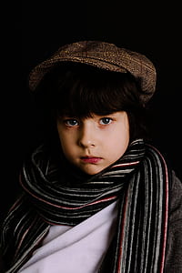 portrait photography of boy wearing striped scarf thumbnail