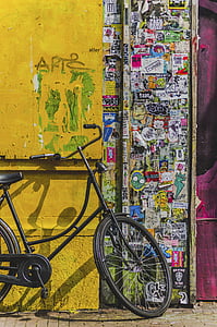 black cruiser bicycle parked near door thumbnail