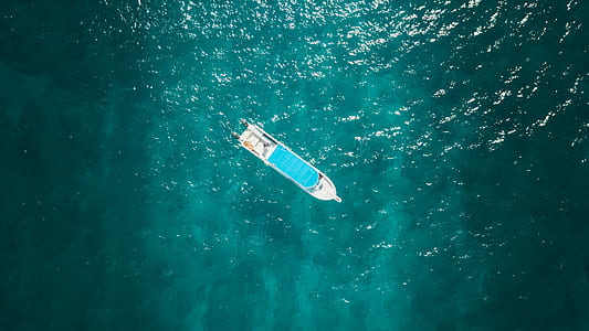 aerial view of white boat on body of water thumbnail