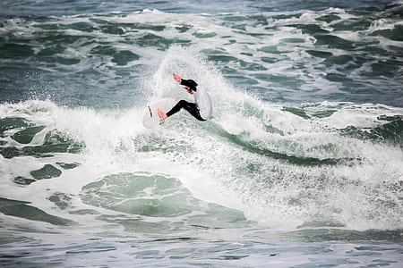 man surfing during daytime thumbnail