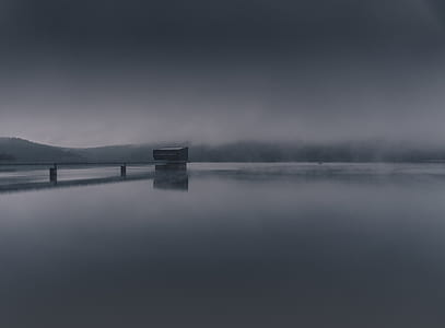 boat dock on body of water with mist background thumbnail