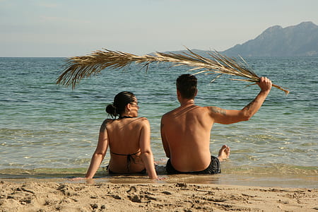 couple sitting on seashore thumbnail