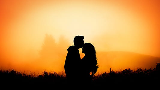 silhouette of man kissing on woman forehead thumbnail