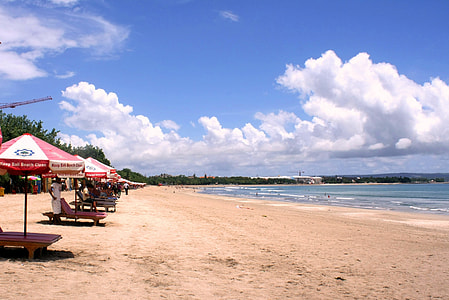 photography of seashore with kiosks under alto cumulus clouds and blue calm sky thumbnail