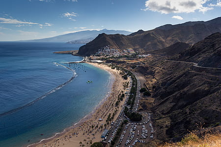 aerial photography of mountain near seashore thumbnail