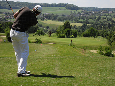 man playing golf near trees at daytime thumbnail