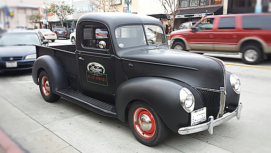 classic black single cab pick-up truck on street thumbnail