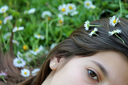 tilt lens photography of woman's face with 4 flowers on her hair thumbnail