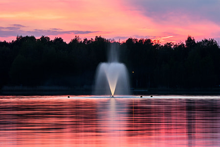 fountain in middle of body of water during daytime thumbnail