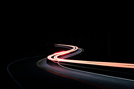 timelapse photography of vehicle on winding road thumbnail