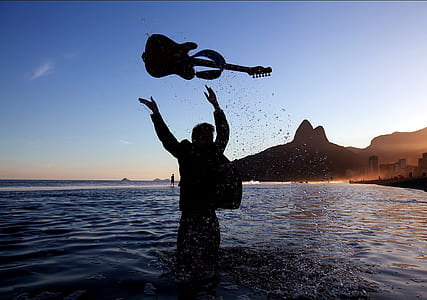 person in water throwing guitar thumbnail