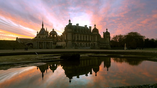 reflection photography of castle under golden hour thumbnail