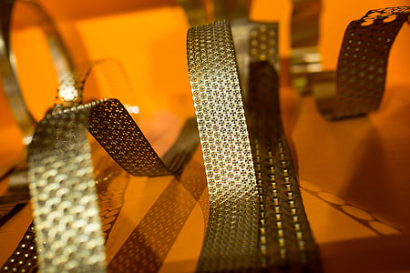 Bended golden metal on an orange background thumbnail