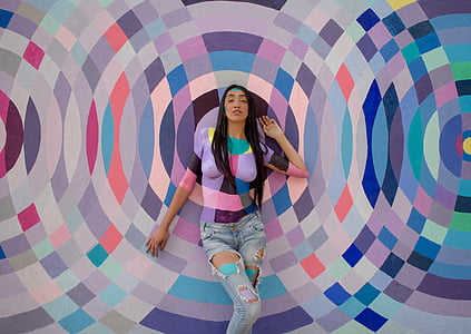 woman leaning on abstract wall painting thumbnail