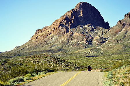 person riding on motorcycle in between green leafed plants thumbnail