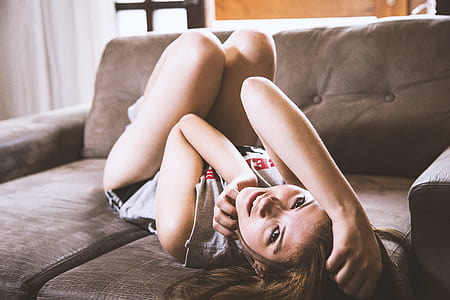 woman laying on gray couch thumbnail
