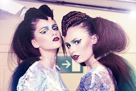 two women in white and purple tops thumbnail