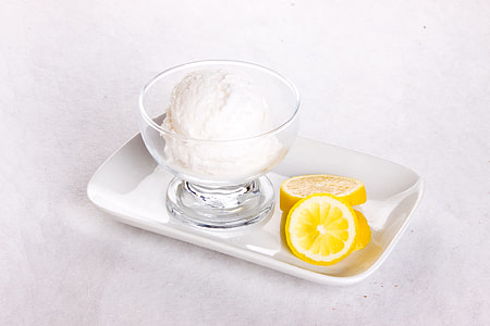 sliced lemon near short-stem glass on white ceramic tray thumbnail