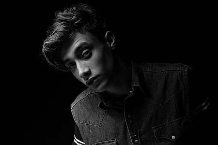 grayscale photo of man in denim vest thumbnail