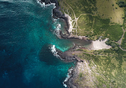 aerial photography of cliff and sea at daytime thumbnail