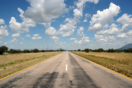 landscape photography of road under cloudy sky during daytime thumbnail