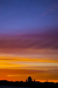 silhouette of buildings under cloudy sky thumbnail