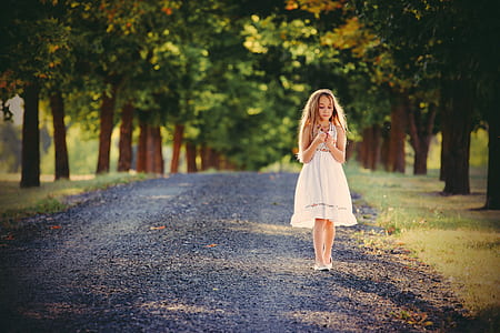 girl walking surrounded trees thumbnail