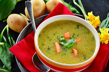 soup on white, orange, and red ceramic bowl thumbnail