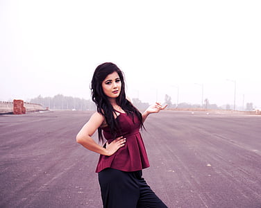 woman wearing maroon spaghetti strap top and black skirt thumbnail