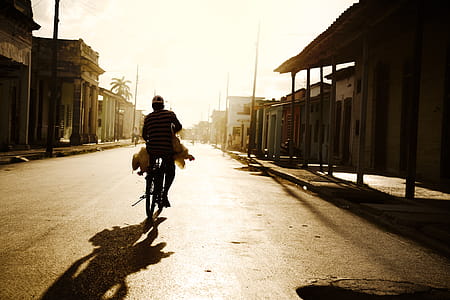 Person Riding on Bike Photo Shot during Daylight thumbnail