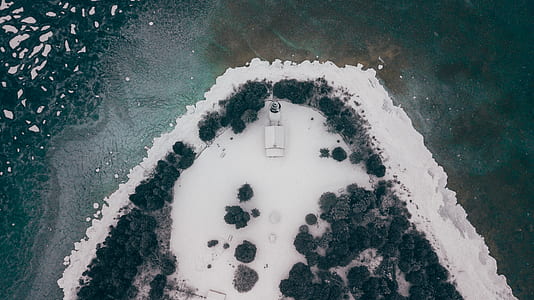 aerial view of house at snowfield near body of water thumbnail