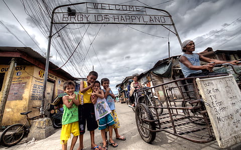 children standing below Brgy. Happy Land sign thumbnail