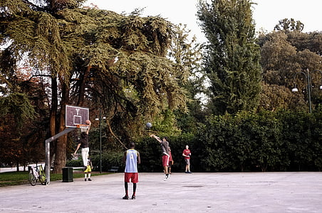 men playing basketball in front of gray and red basketball hoop thumbnail
