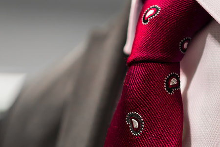 person wearing red paisley necktie thumbnail