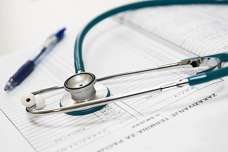closeup photo of blue stethoscope on white printed paper thumbnail